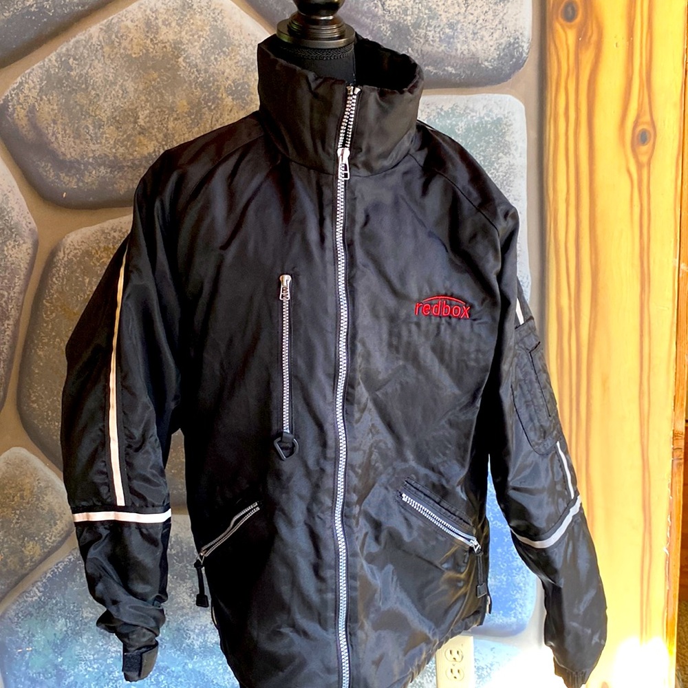 Heavy winter jacket with reflective stripes on the sleeves.